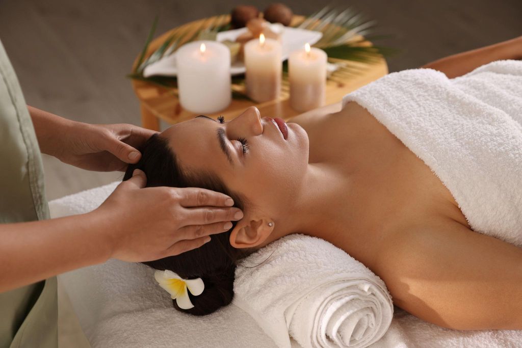 A peaceful spa massage with soft towels and candles